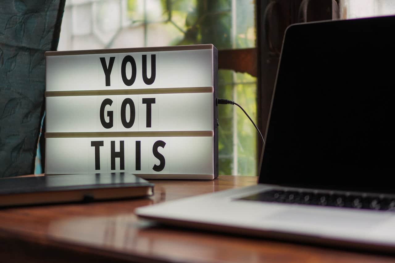 "You got this" sign next to a laptop